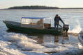 taxi boat coming to shore at moosonee through sheet ice