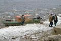 loading a wood stove into a taxi boat at moosonee